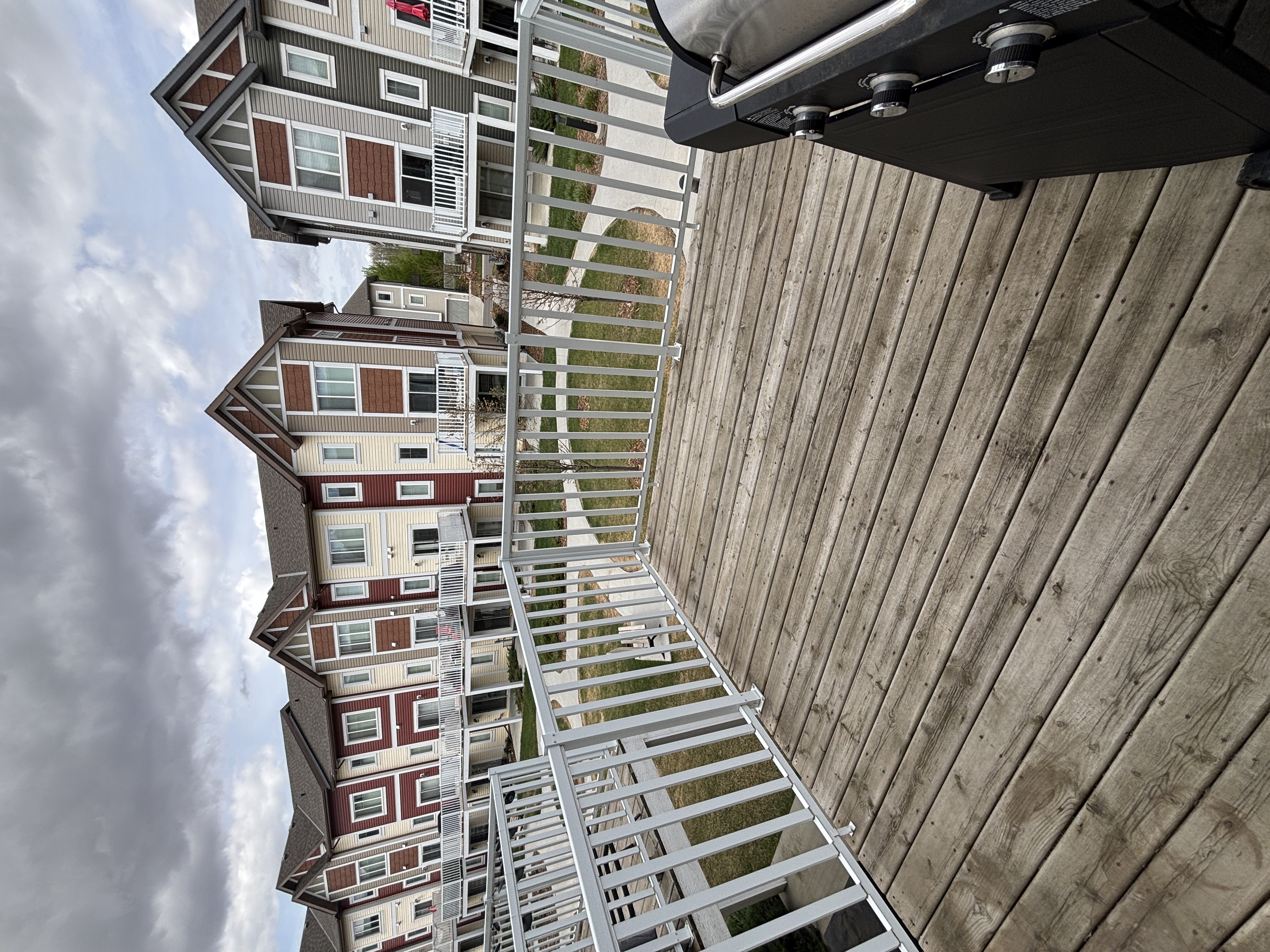 A tall building with a wooden facade and a metal staircase.